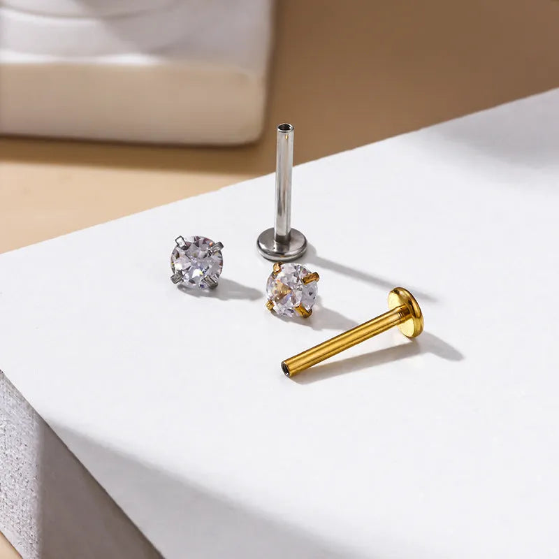 Stainless steel inner rod ear bone stud with geometric shape and electroplated finish on silver background
