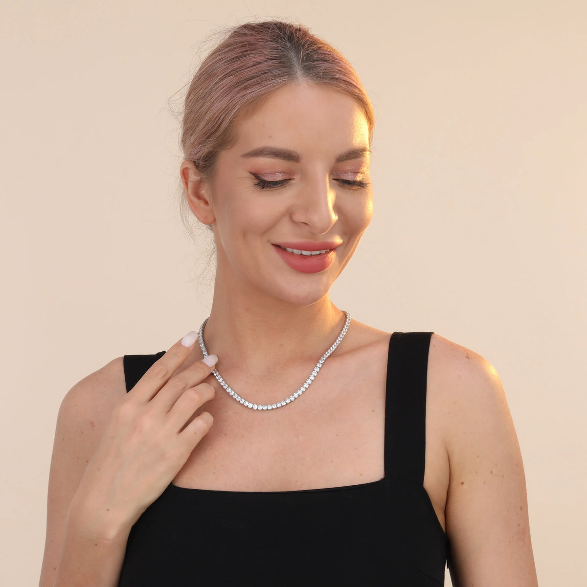 925 sterling silver tennis chain necklace with 4mm cubic zirconia stones and white gold plating on white background