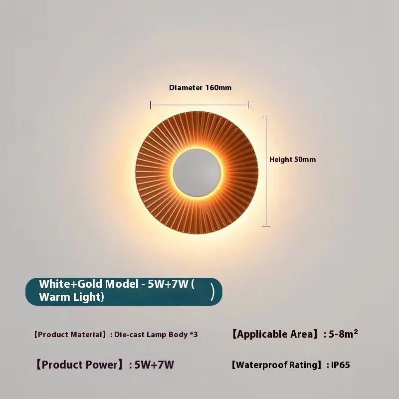 Round aluminium wall lamp with LED light in a white and gold colour option.