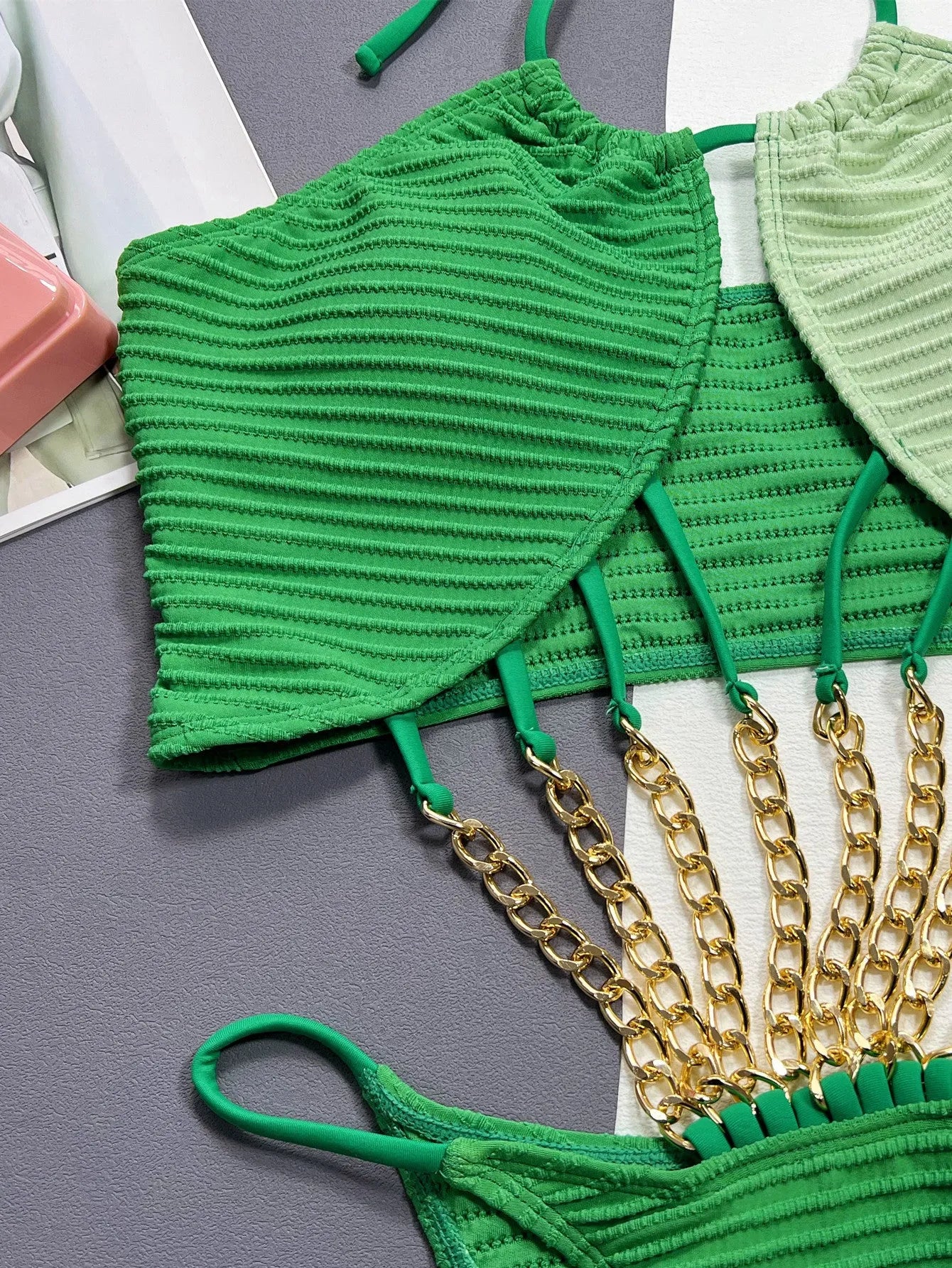 Green women's one-piece swimsuit with a hollow cutout design on the front.