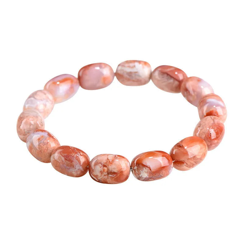 Natural cherry agate bracelet with barrel-shaped beads and a Ruyi design element on a wrist.