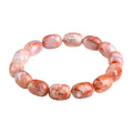 Natural cherry agate bracelet with barrel-shaped beads and a Ruyi design element on a wrist.