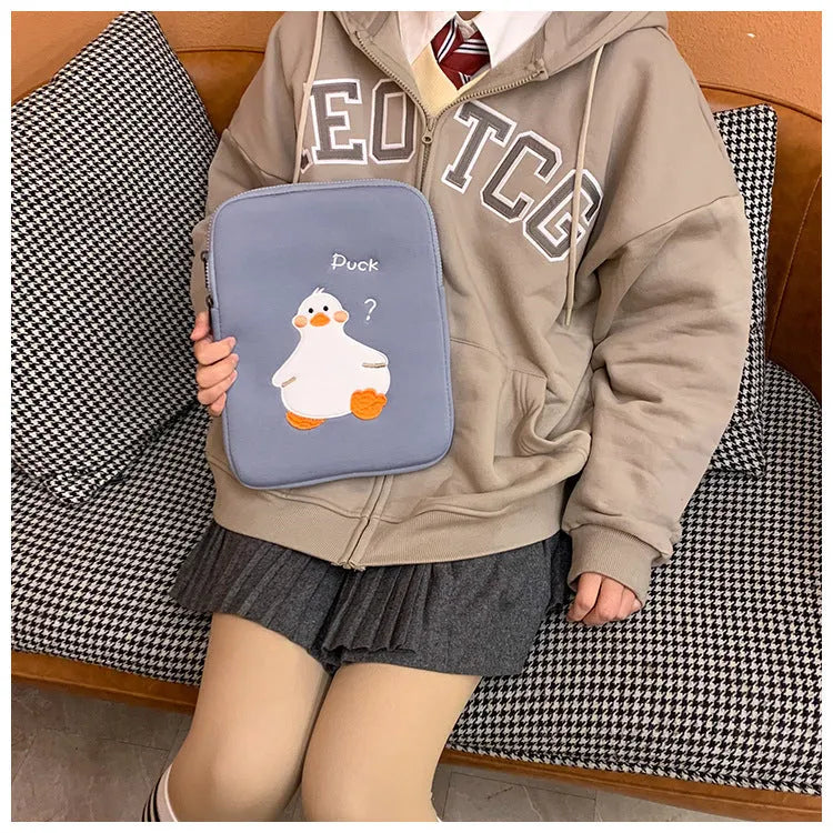 Blue cotton tablet case with a cartoon duck embroidery design and a silver zipper closure.