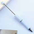 Colourful spinning ballpoint pen with plastic beads on a white background.
