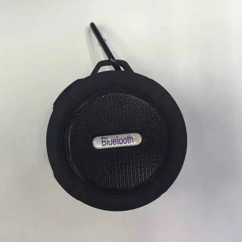 Compact waterproof Bluetooth speaker with a mounting strap in black, blue, green, red, or yellow.