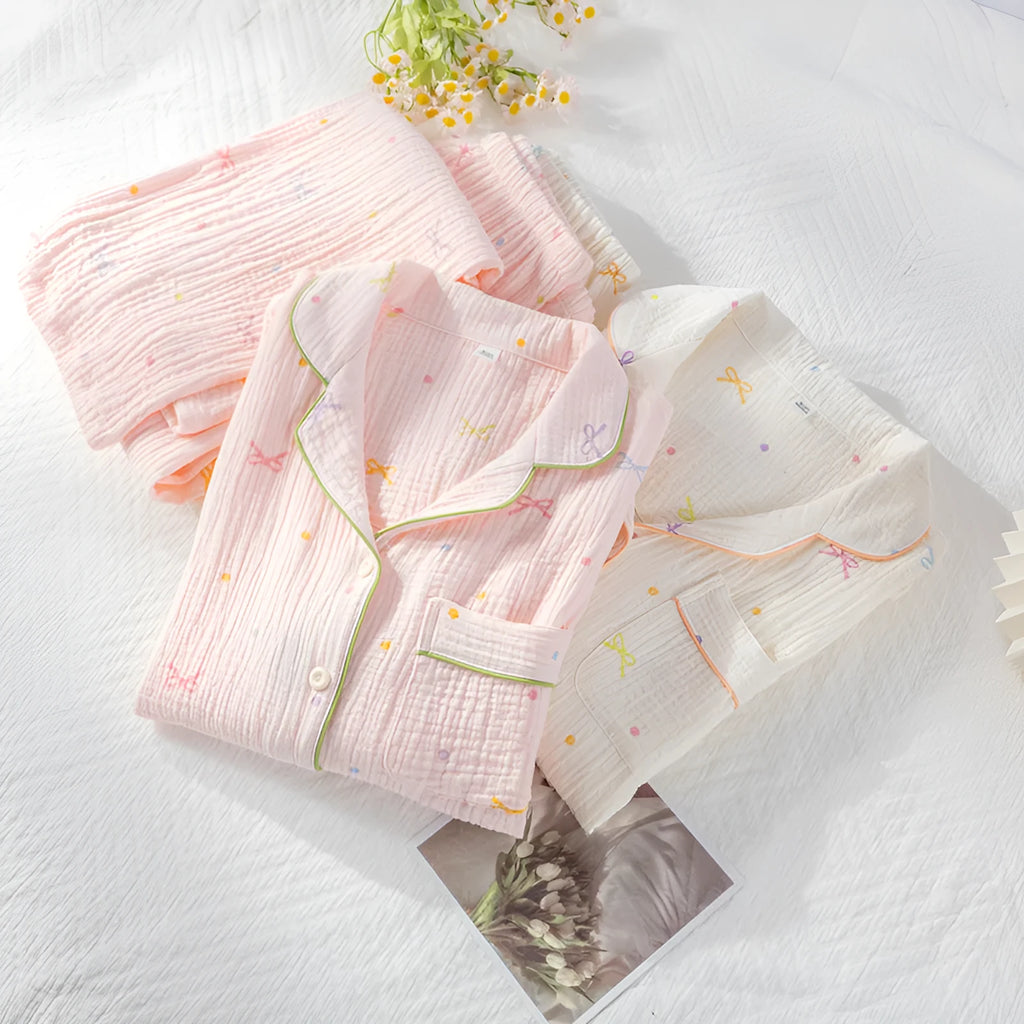 Women's thin cotton long-sleeve pajama set in beige, showing top and trousers laid flat.