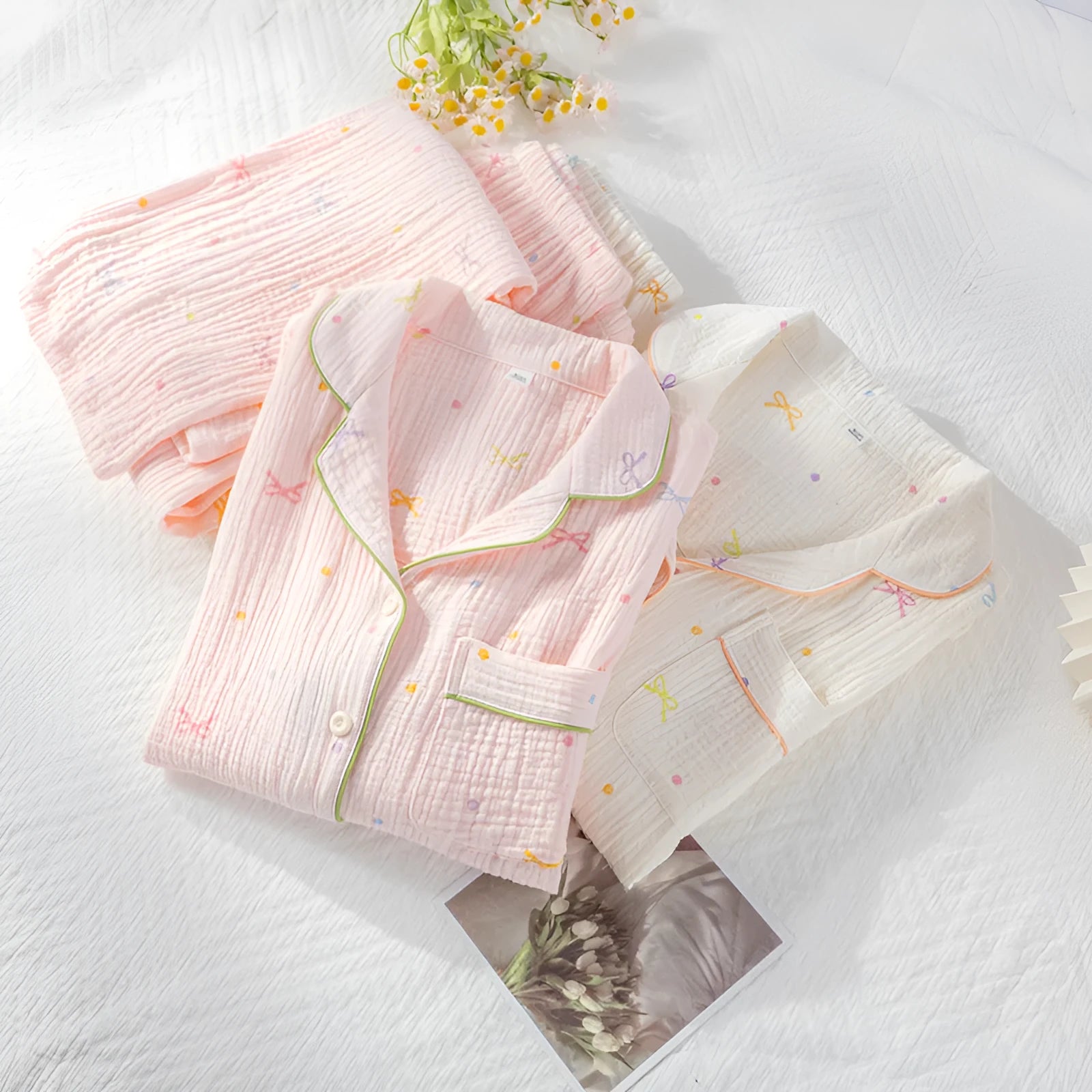 Women's thin cotton long-sleeve pajama set in beige, showing top and trousers laid flat.