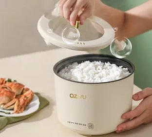 Compact round miniature rice cooker with steam pan and non-stick liner for one to two person cooking