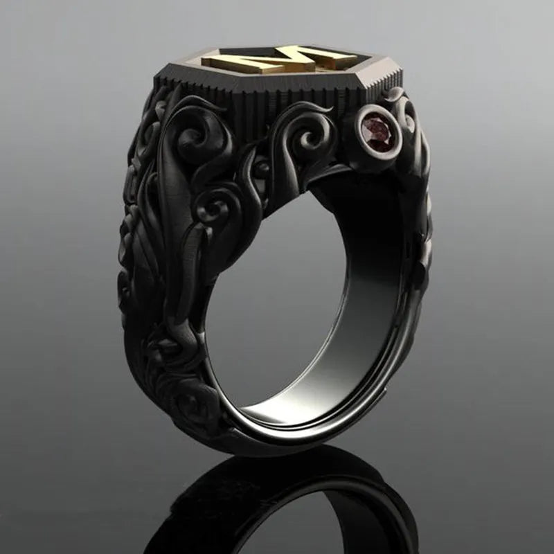 Black alloy decorative ring with carved leaf design on white background