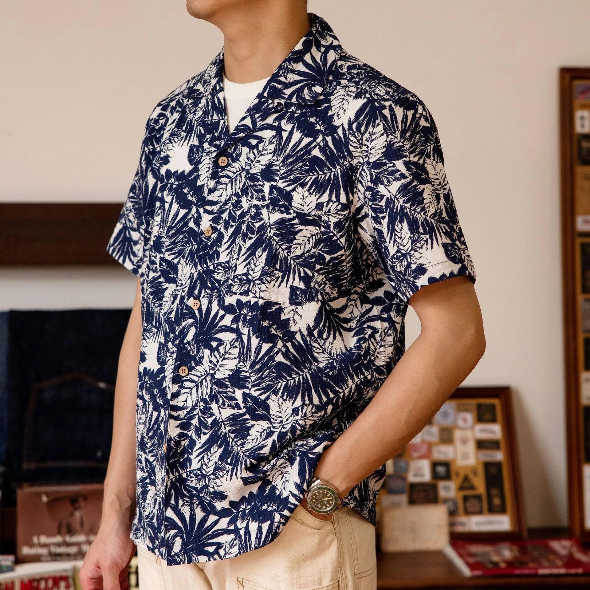 Vintage floral print seersucker shirt with a Cuban collar on a mannequin, shown in blue and green.
