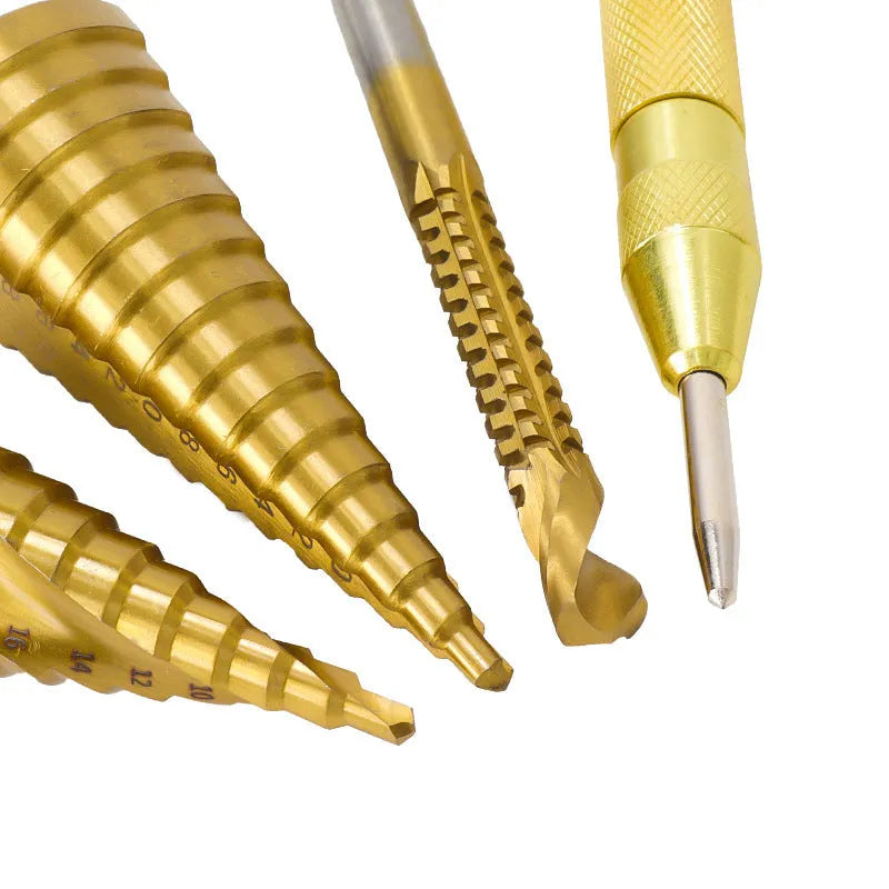 High-speed steel step drill bits and a centre punch set on a workbench, showing colour-coded tools.