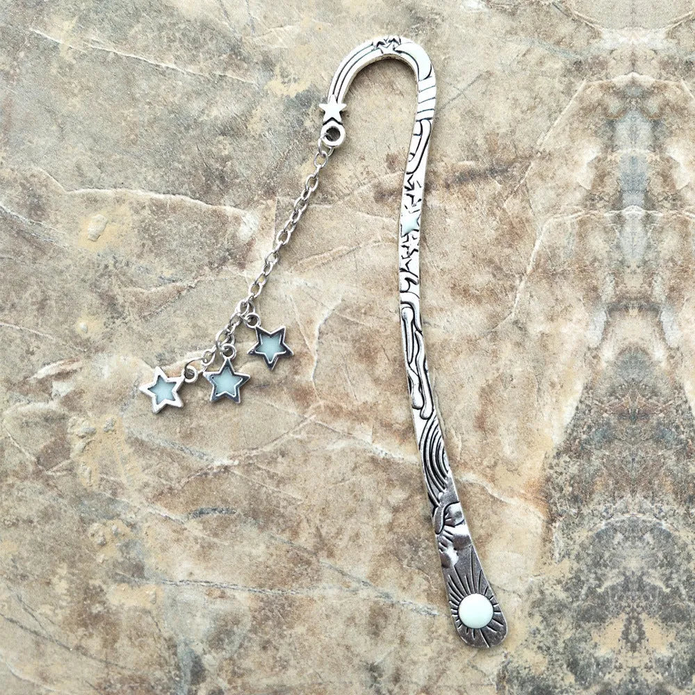 Retro five-pointed star metal bookmark with fluorescent detail in ancient silver or bronze celestial design