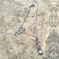 Retro five-pointed star metal bookmark with fluorescent detail in ancient silver or bronze celestial design