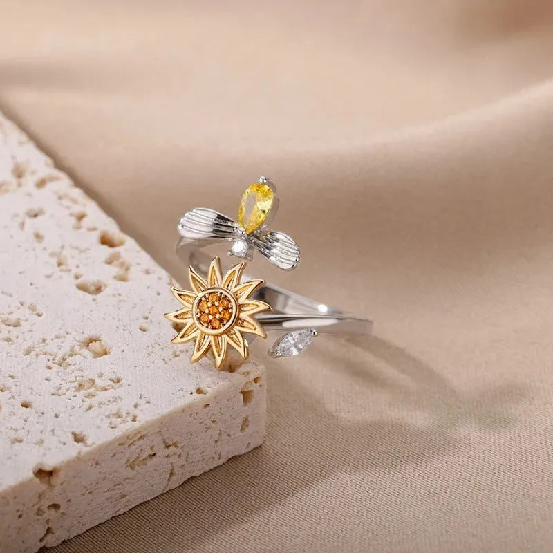 Adjustable decompression ring with rotatable band in gold or platinum finish