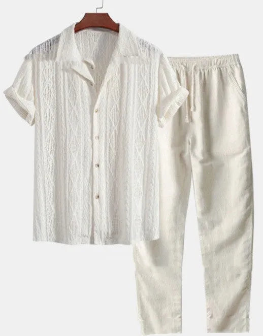 Man wearing a loose short sleeve shirt and matching trousers from the milk silk summer suit set.