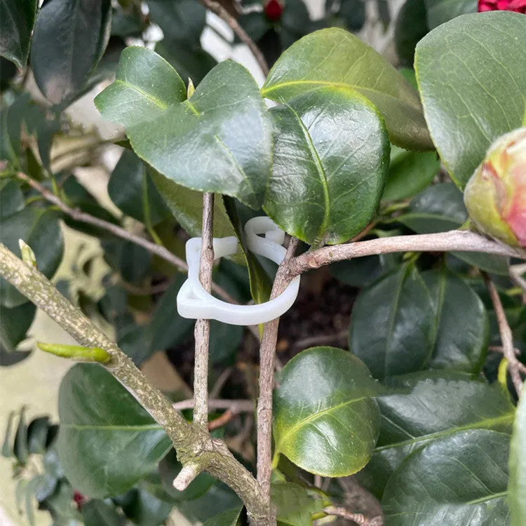 Colourful cat-shaped plastic plant clip for garden stem support.