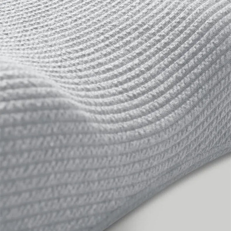 Grey memory foam massage pillow with knitted cotton cover and adjustable loft for neck support