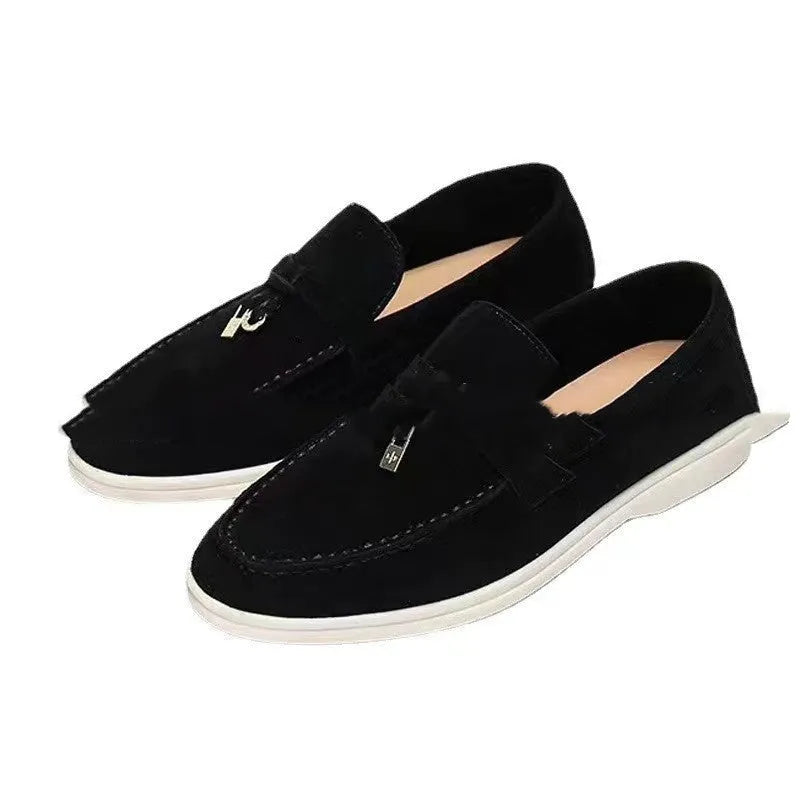 Unisex black slip-on casual loafers with rubber sole and round toe cap on a white background