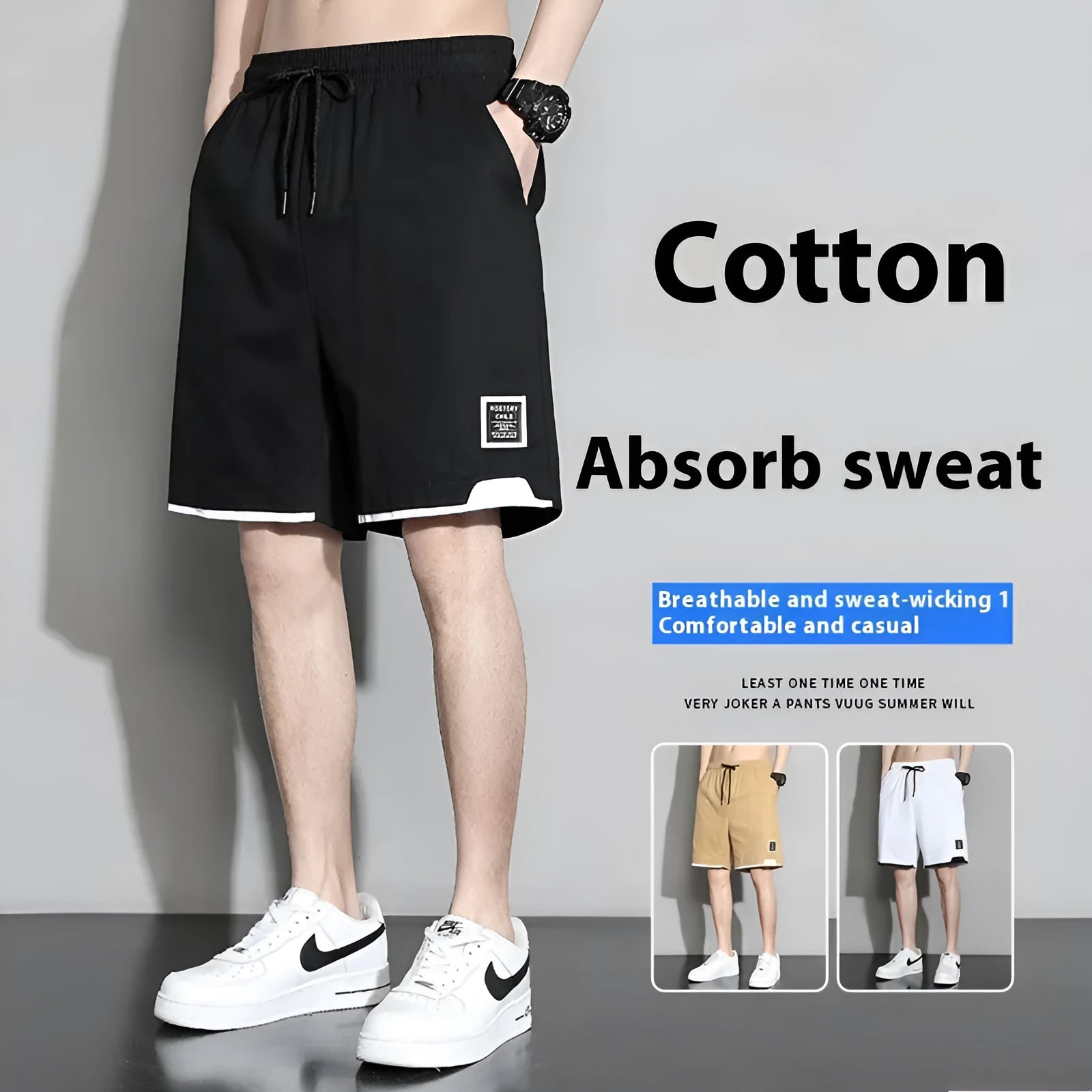 Boys' loose-fitting cotton summer shorts in black, shown on a hanger.