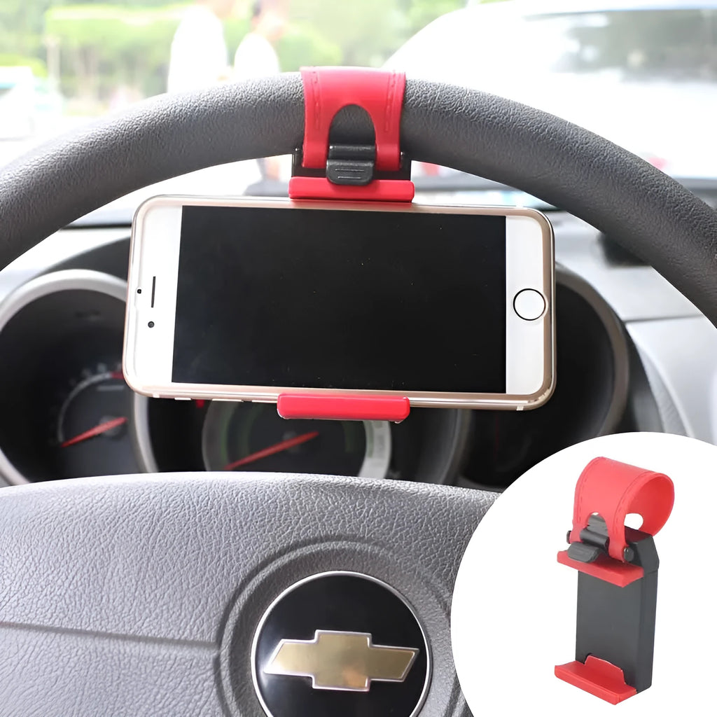 Black universal steering wheel phone holder clip mounted on a car steering wheel, holding a smartphone.