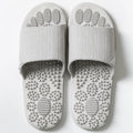 Reflexology acupressure slippers in EVA material with 3D massage particles, available in blue, grey, light blue, pink, purple