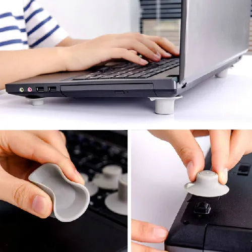 Grey laptop cooling stand with four silicone feet creating an air gap under a silver laptop.