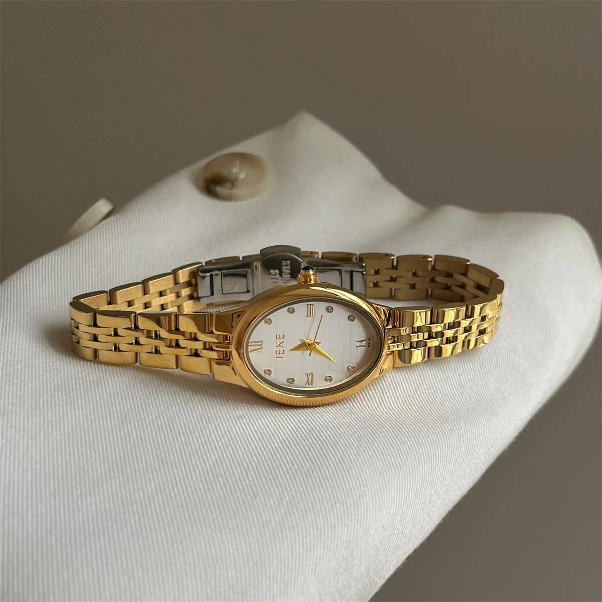 Oval dial ladies watch with dot markers, 37mm, gold strap and gold face