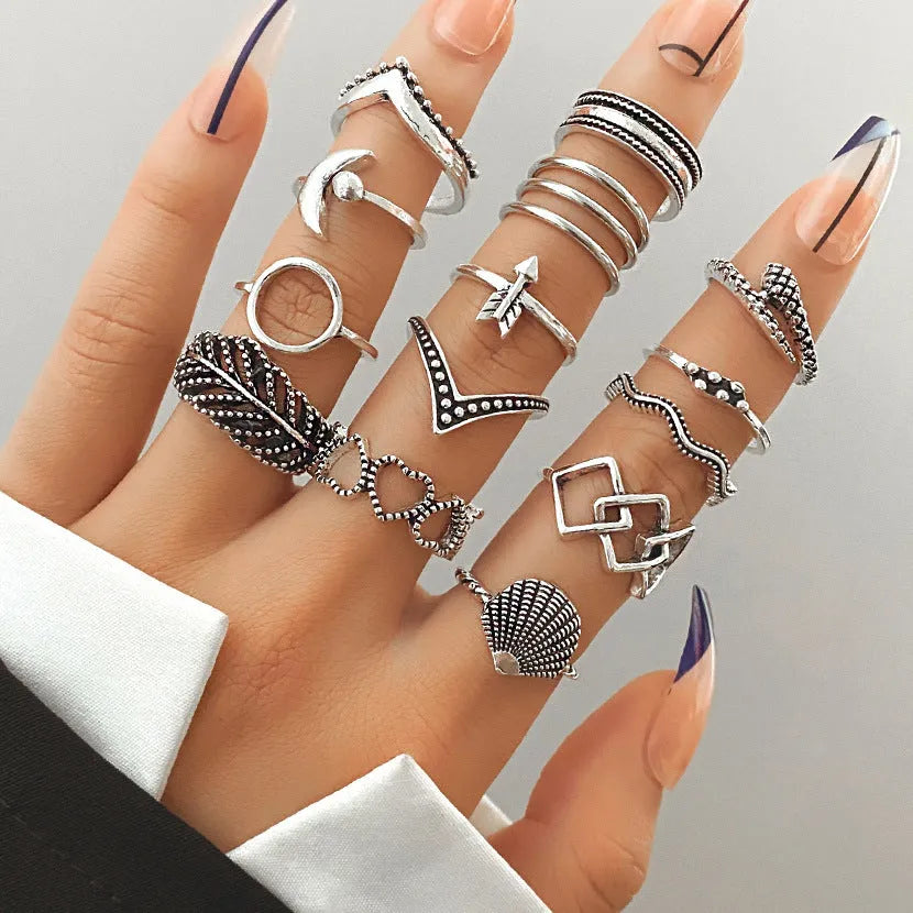 Alloy ring set with butterfly and snake retro geometric designs on display