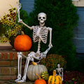 Poseable 90cm tall plastic skeleton Halloween decoration with articulated limbs.