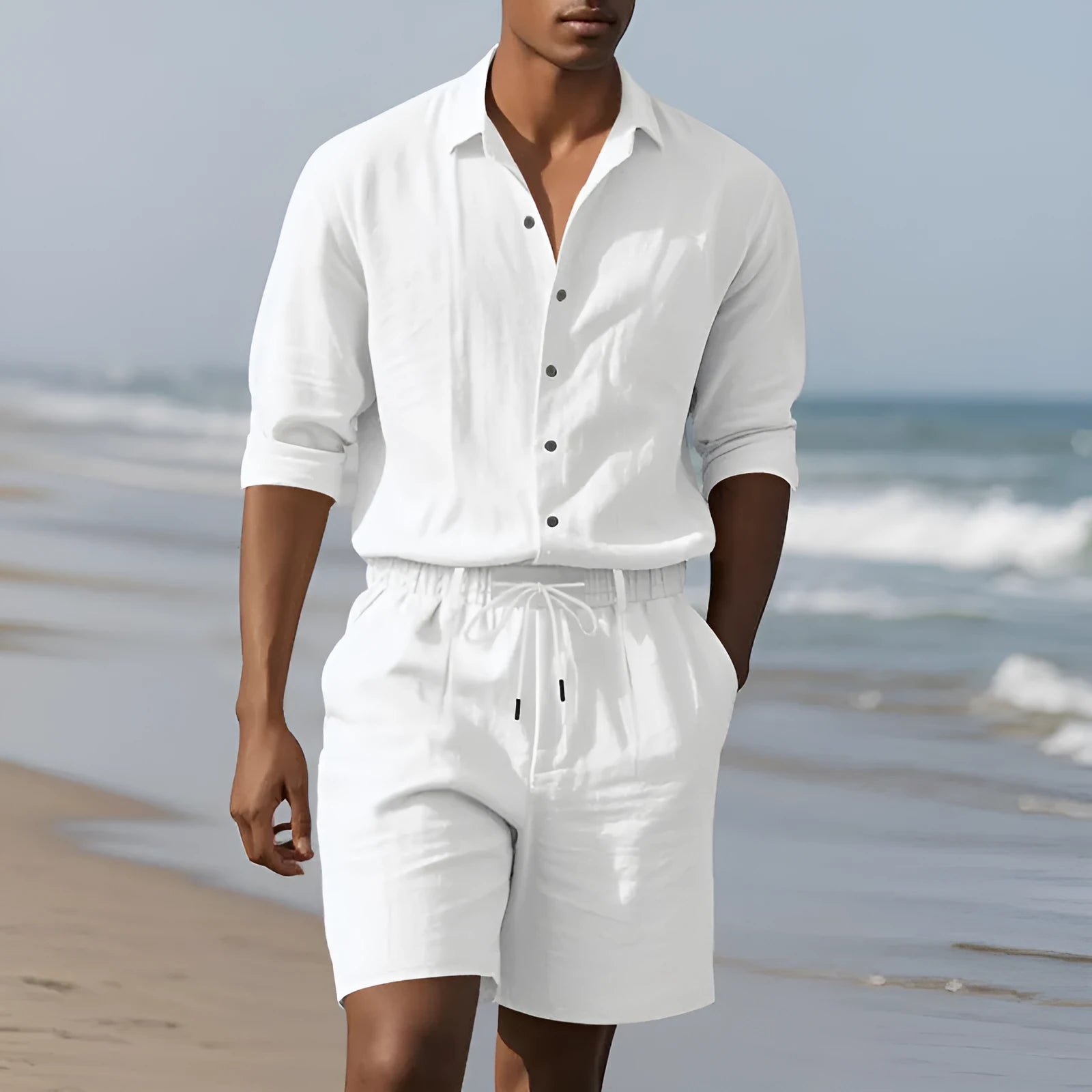 Men's white linen long-sleeve shirt and matching shorts beach suit set laid flat.