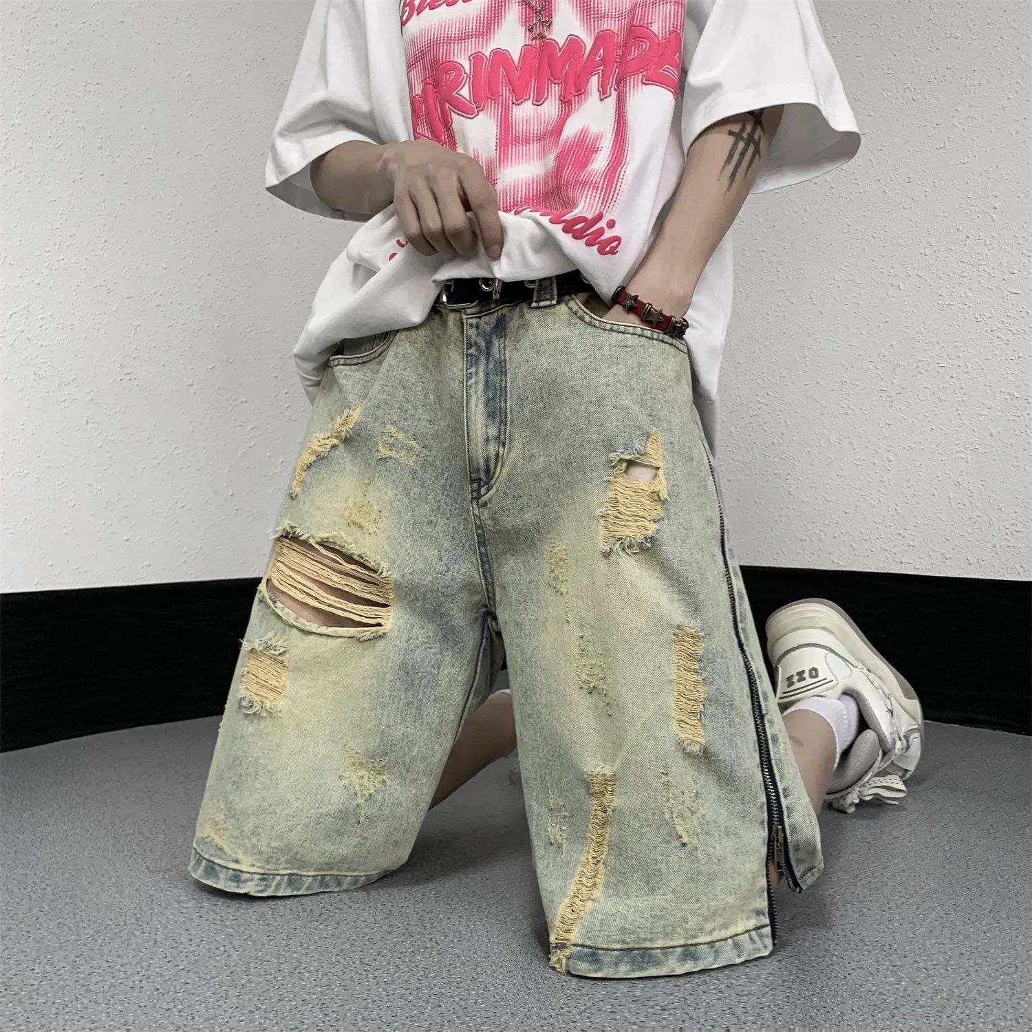 Men's blue retro denim shorts with five-point ripped distressing and yellow mud wash finish