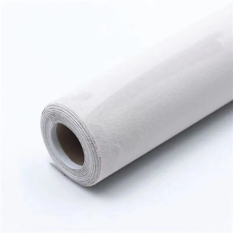Roll of self-adhesive leather suede fabric in BMW brown colour next to a car dashboard.