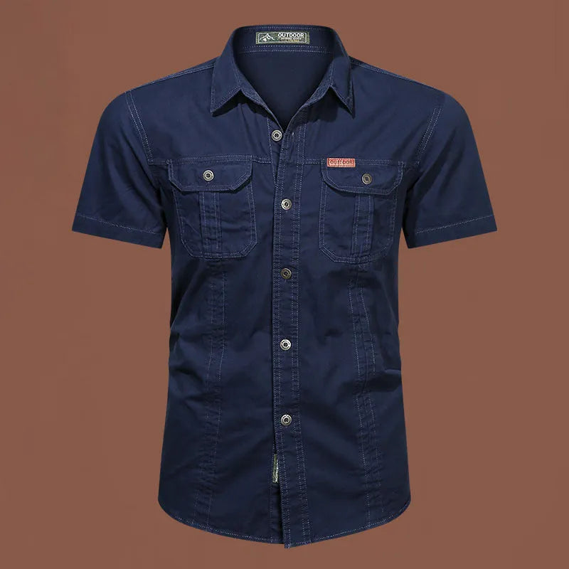 Man wearing a loose-fitting short sleeve cotton work shirt in a cardigan style.