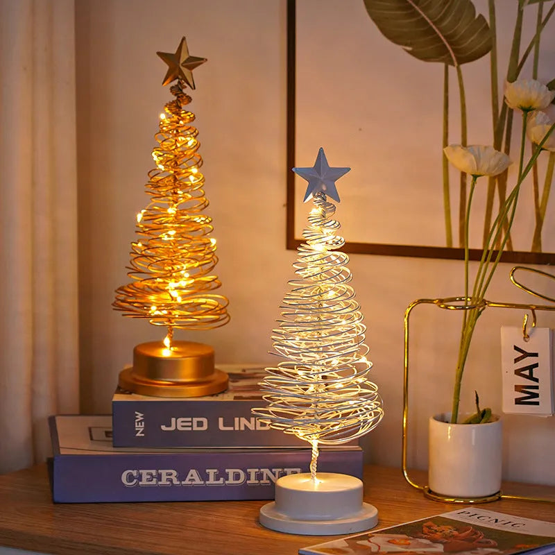 Wrought iron LED Christmas tree spiral light on a table, glowing warm white.