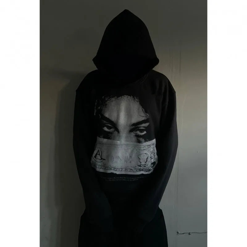 Black women's loose-fit hoodie with a cartoon print, shown in a casual setting.