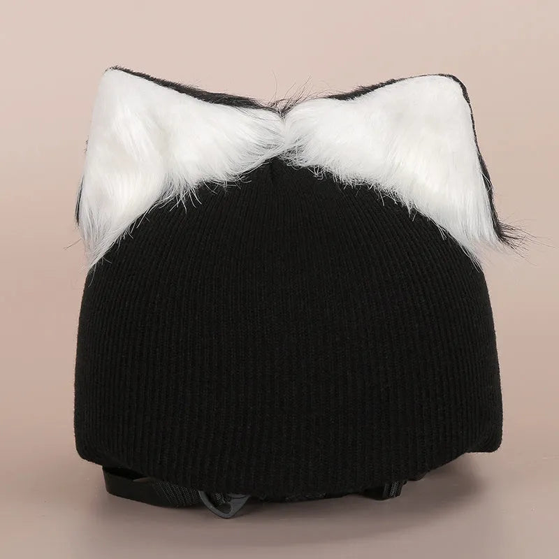 Colourful plush cartoon hat decoration sitting on top of a ski helmet