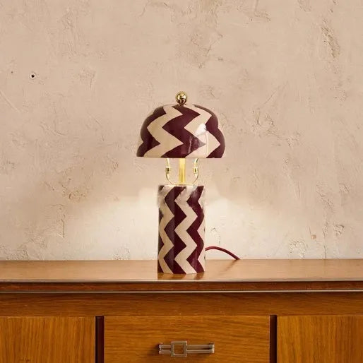 Striped table lamp with matte finish, pushbutton switch, and UK plug on a desk