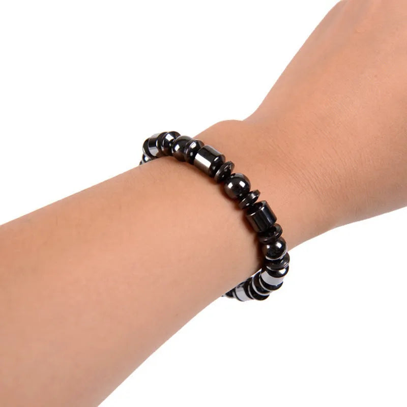 Black pentagram symbol magnetic bracelet with magnetite and hematite stones on a stretch band.