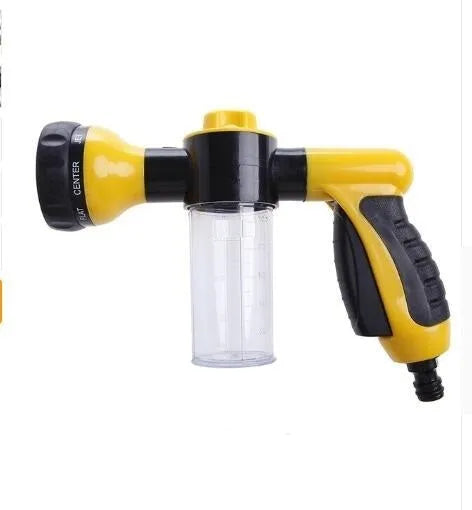 Green high-pressure foam spray gun with adjustable nozzle and attached water hose for car and garden cleaning.