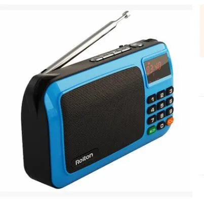 Golden Rolton W405 portable FM radio and MP3 speaker with LED display on a textured surface.