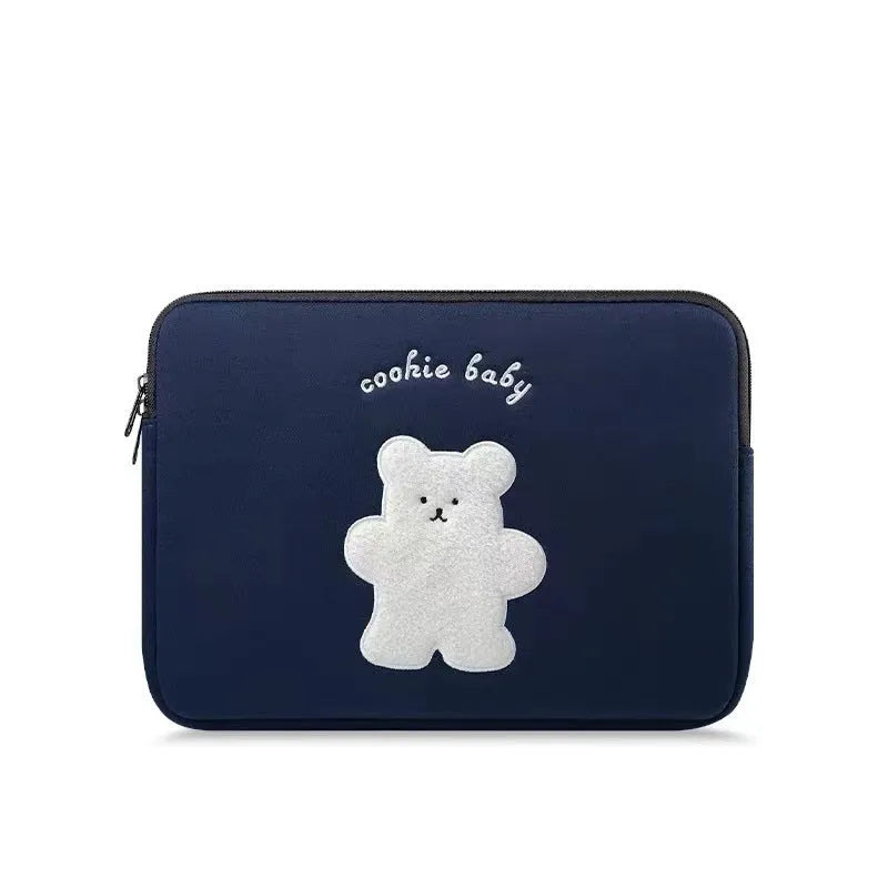 Embroidered animal design laptop sleeve in polyester, shown next to a laptop.