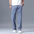 Men's light blue loose straight-leg lyocell jeans with a zipper fly, laid flat.