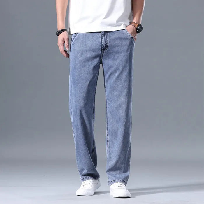 Men's light blue loose straight-leg lyocell jeans with a zipper fly, laid flat.