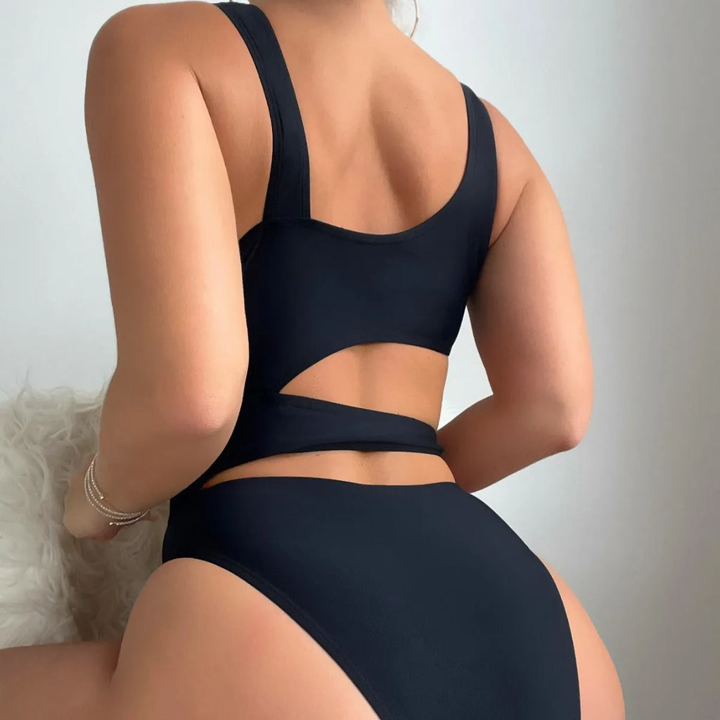 A solid black women's one-piece swimsuit with a high cut leg design on a mannequin.