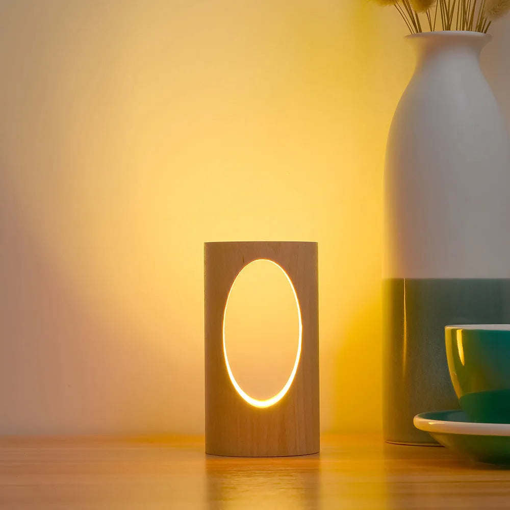 Solid wood LED reading lamp with glass lampshade on a desk, USB cable visible
