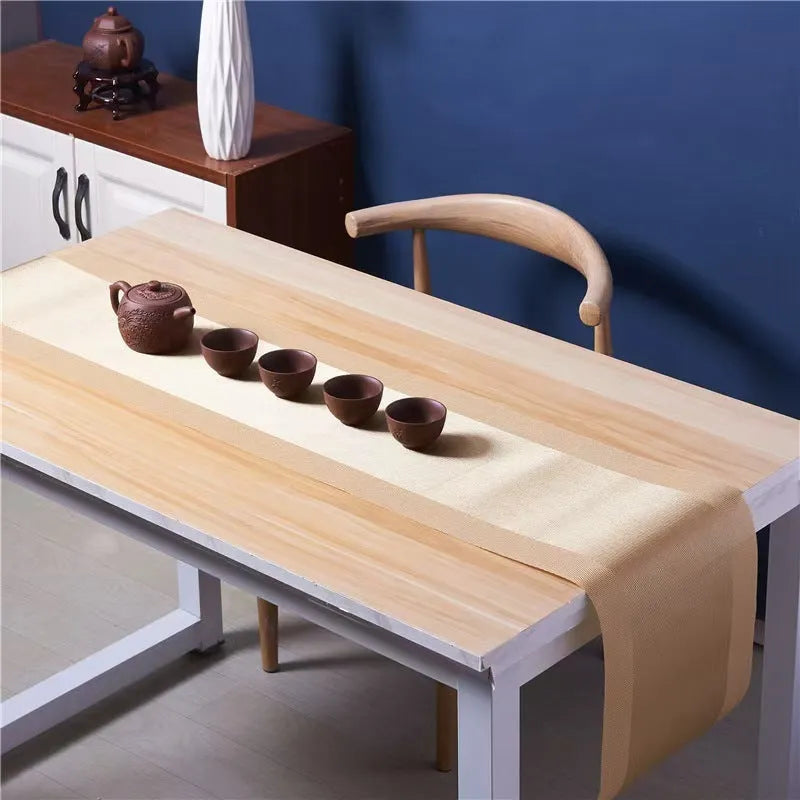 Modern non-slip PVC dish mat with gradient bamboo pattern in black, placed on a wooden dining table.
