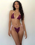 Women's solid colour bikini swimsuit with bow tie detail on top, shown in multiple colour options