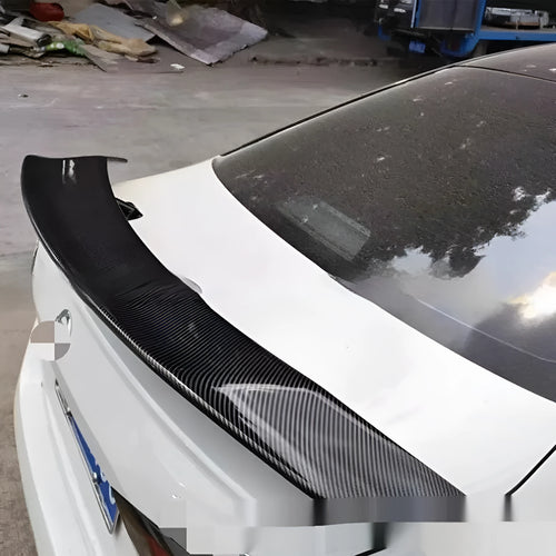 Universal punch-free car spoiler in ABS plastic showing blank, black, white, and carbon pattern finish options.