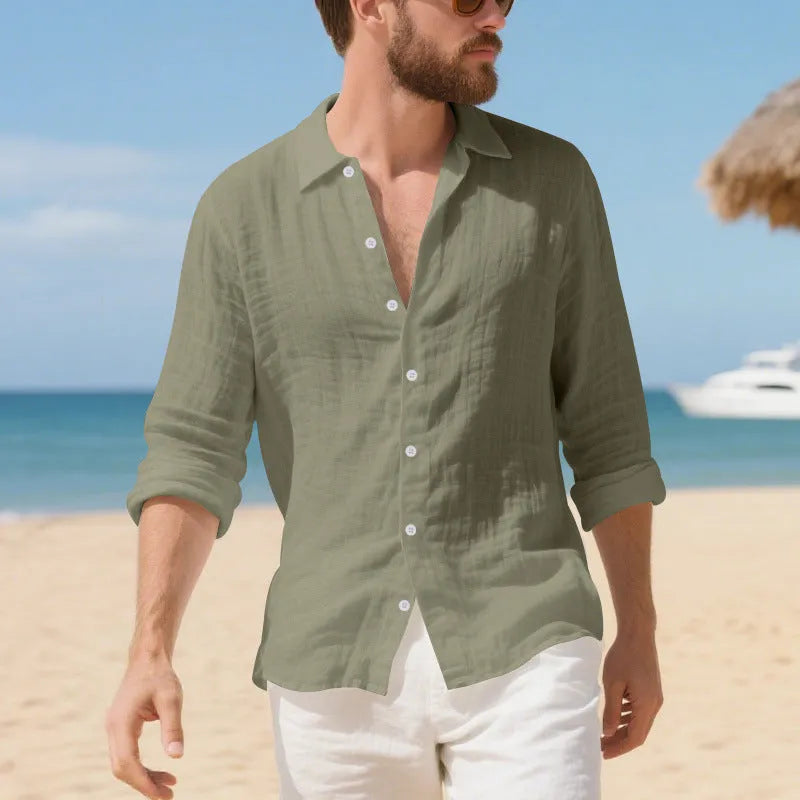A man wearing a loose-fit light blue linen casual shirt with a non-iron finish, buttoned front and standard collar.