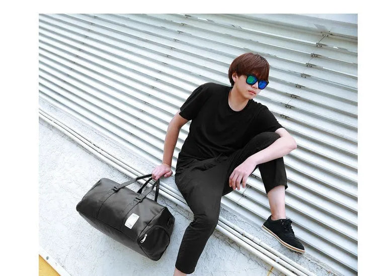 Black waterproof sports fitness bag with separate shoe compartment and diagonal shoulder strap.
